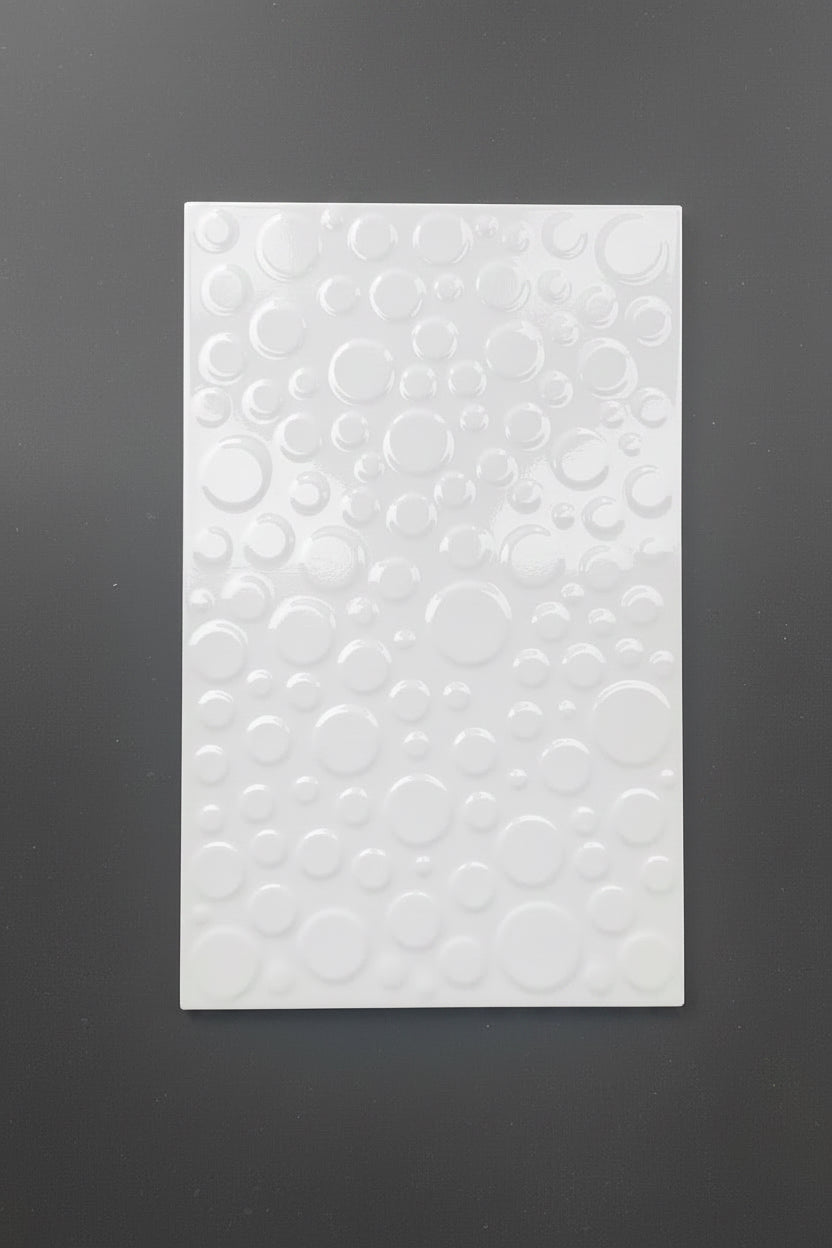 A rectangular white textured panel featuring an embossed pattern of overlapping circles, displayed against a dark gray background.
