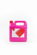 A large bright pink plastic container of Peraclean cleaning compound with a red cap, displayed on top of blue boxes in a cluttered storage or shop environment.