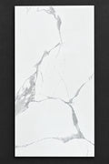 A rectangular white marble-look tile with gray veining and the printed code 360011 in the top-left corner, shown against a neutral gray background.