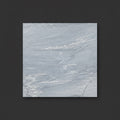 A square light gray marble-look tile or slab sample with subtle white veining, centered on a dark charcoal background.