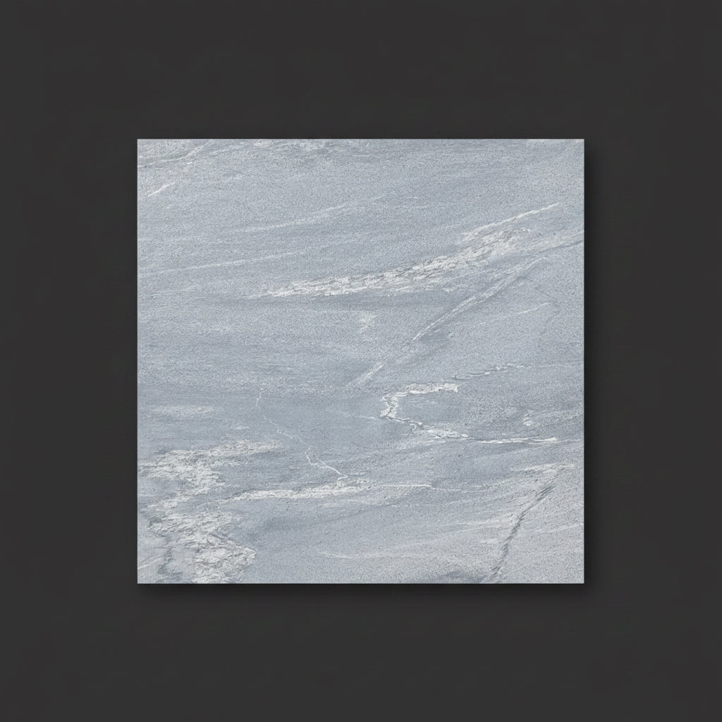 A square light gray marble-look tile or slab sample with subtle white veining, centered on a dark charcoal background.