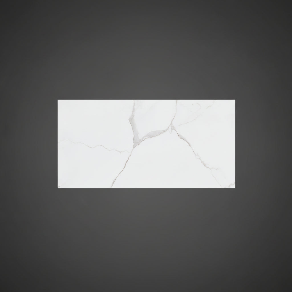 A rectangular white porcelain tile with a gray marble-look veining pattern is displayed on a beige tiled floor.