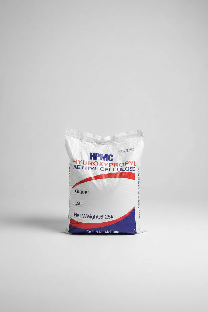 A white bag of HPMC Hydroxypropyl Methyl Cellulose, 6.25kg net weight, placed on a concrete floor next to stacks of wood panels.