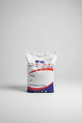 A white bag of HPMC Hydroxypropyl Methyl Cellulose, 6.25kg net weight, placed on a concrete floor next to stacks of wood panels.