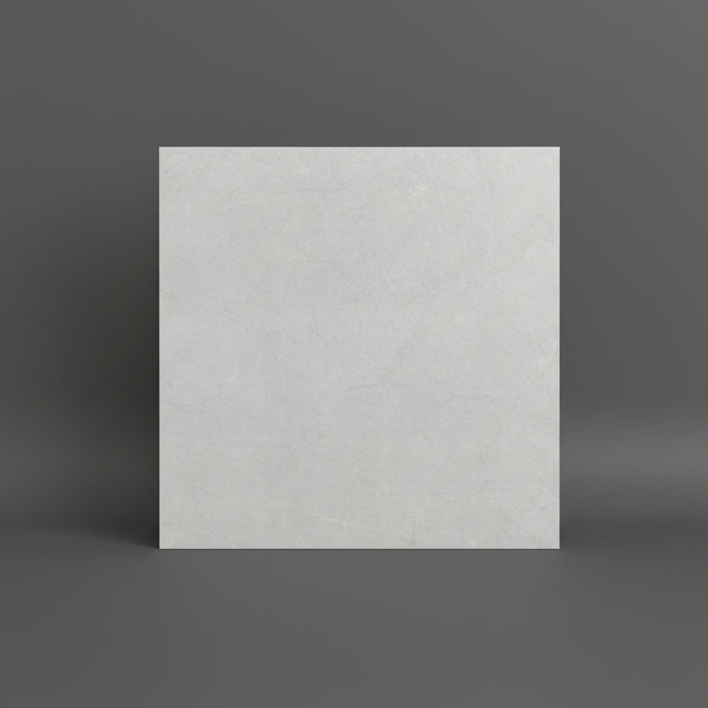 light gray textured tile or stone sample lies on a tan tiled floor 60x60cm roustic